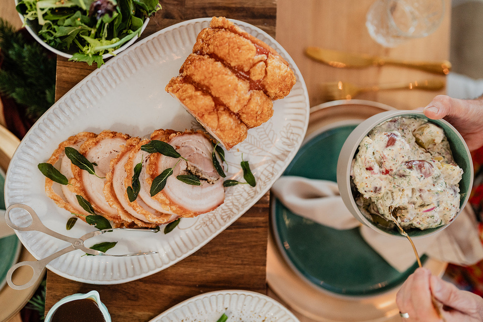 Roast pork dinner with potato salad and Christmas themed dinner table